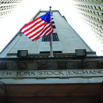 A flag flutters in the wind outside the New York Stock Exchange
