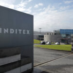 An Inditex logo is seen at the entrance of a Zara factory, the headquarters of Inditex group, in Arteixo